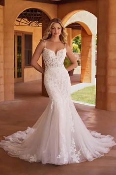 a woman in a wedding dress posing for the camera