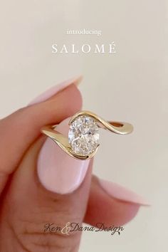 a woman's hand holding a ring with a diamond in it and the words, salomee