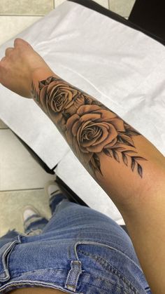 a person with a rose tattoo on their arm