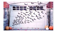 a garage door decorated with bats and pumpkins