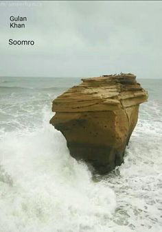 a large rock sticking out of the ocean