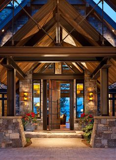 the front entrance to a home with stone pillars