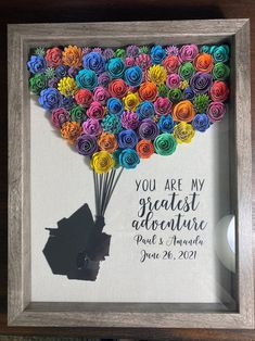 a framed photo with paper flowers in the shape of a hot air balloon