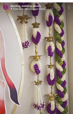 the wall is decorated with purple and white beads