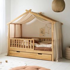 a child's bed with a canopy over it