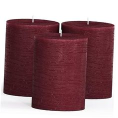 three red candles sitting next to each other