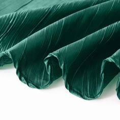 green pleated fabric folded on top of each other