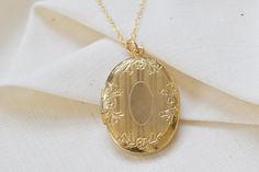 The perfect gift for a bride, mother, graduate, or birthday. Find affordable antique and vintage inspired jewelry here. Personalize by adding sentimental pictures, a tiny note, or a lock of hair. Select the customization option if you would like me to personalize before shipment. This oval antique locket features a sleek floral engraving on the front.  | PRODUCT DETAILS | * Style: Vintage * Circa: late 1900's * Measurements: approx. 1 3/8" total length * Locket Material: Gold Fill * Chain Detail Cheap Vintage Gold Locket Necklace, Engraved Antique Gold Locket Necklace, Luxury Antique Engraved Locket Necklace, Antique Gold Engraved Metal Locket Necklace, Ornate Engraved Antique Gold Locket Necklace, Antique Gold Engraved Locket Necklace Collectible, Ornate Engraved Brass Locket Necklace, Antique Style Jewelry, Engraved Locket