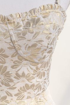 A chic and unique dress, the Heart of Gold mini features removable shoulder straps, a bustier-style bodice, smocked elastic back, and enchanting gold floral jacquard. Perfect for bridal showers, cocktail soirées, or graduation parties. Please Note- This item is final sale only. . Details: S: Bust: 32"-36", Waist: 26"-29" M: Bust 34"-38", Waist: 28"-31" L: Bust 36"-40", Waist: 30"-33" Length Bustier to Hem: 27" Length Waist to Hem: 18" Lined Material: 54% Polyester, 46% Cotton Lining: 100% Rayon Gold Dress With Spaghetti Straps And Fitted Bodice, Gold Dresses With Spaghetti Straps And Fitted Bodice, Gold Mini Dress With Sweetheart Neckline, Gold Fitted Mini Dress With Sweetheart Neckline, Gold Summer Dress With Sweetheart Neckline, Gold Mini Dress, Mini Gold Dress, French Dress, Graduation Parties