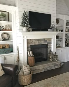 a living room filled with furniture and a flat screen tv on top of a fireplace