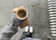 a person is holding a cup of coffee