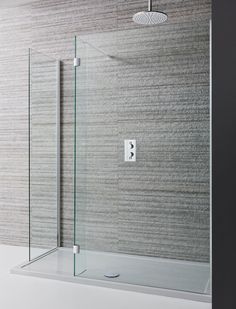 a glass shower door with the handle on it's side and an overhead shower head