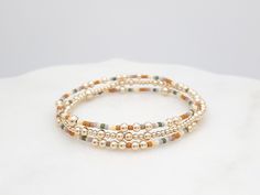 ◉ This listing is for a single bracelet, or a stack of 3. ◉ Bracelet Set Each bracelet is made with flexible elastic, making the set easy to wear individually or stacked for a layered, meaningful touch to your everyday style. ◉ Feature  - 2mm 14k Gold Filled Beads - 3mm 14k Gold Filled Beads - 4mm 14k Gold Filled Beads - 2mm Miyuki seed beads - Stretch Cord, pre-stretched to stay the same size ◉ Sizing Tips Please measure your wrist to find your best fit. 1. Gentry wrap a soft measuring tape or tape around your wrist. 2. Add 1/4" to the measurement for a snug fit or 1/2" to the measurement for a comfortable fit. ◉ Shipping Canada: - Free Standard Shipping via Canada Post. (No tracking) - Tracked Shipping available through Chit Chats. USA: All orders include tracked shipping through Chit Ch Single Bracelet, Bracelet Dainty, Dainty Bracelet, Minimalist Bracelet, Dainty Bracelets, Elastic Bracelet, Canada Post, Seed Bead Bracelets, Measuring Tape