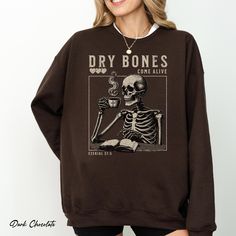 Wrap yourself in comfort with our cozy hoodie featuring a fun graphic, accompanied by the phrase "Dry Bones Come Alive," referencing Ezekiel 37:5. Available in 8 stylish colors, this hoodie is perfect for those who appreciate a blend of humor, faith, and cozy vibes. Ideal for church gatherings, Bible study groups, or simply relaxing at home with a warm drink, it's a great choice for anyone who loves a mix of spirituality and comfort. A thoughtful gift for friends and family who cherish both thei Dry Bones Come Alive, Ezekiel 37, Christian Fall, Dry Bones, Jesus Coffee, Cozy Hoodie, Cozy Vibes, Comfort Color, Fall Sweatshirt