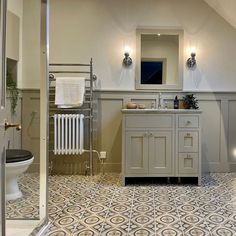 a bathroom with a toilet, sink and bathtub in the middle of an open floor plan