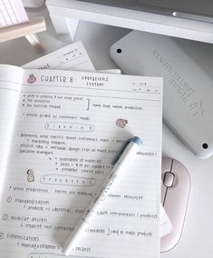 a pen sitting on top of a piece of paper next to a keyboard and mouse