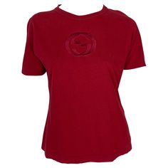 Presenting a red branded Gucci t-shirt, designed by Tom Ford. From the Spring/Summer 1997 collection, this classic crewneck t-shirt is perfectly elevated with a large embossed Gucci 'GG' logo at the chest. This unisex t-shirt has the perfect Gucci by Tom Ford elevated touch. Approximate measurements: Size - Extra Small 22.5" shoulder to hem 38" - 42" bust 36" - 40" waist 7.5" shoulder to cuff 4" underarm to cuff 100% Cotton Luxury Gucci Embroidered Logo Tops, Luxury Gucci Elegant Tops, Gucci By Tom Ford, Gucci T Shirt, Gucci Top, Gg Logo, Red Tshirt, Primavera Estate, Logo Embroidered