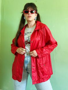 "+ comfy, casual, & colorful vintage eighties windbreaker jacket in an ultra bright & bold shade of red + relaxed, sporty shape with long sleeves, open shoulders, collared neckline, & brass snap front closure (with more snap closures at each pocket & sleeves cuff) + two front pockets at each hip & a small zipper pocket at the right chest + small stretchy elastic insert at the center back of jacket to aid in fit  + 100% nylon ~ feels like the classic lightweight, swishy material with a bit of ref Red Relaxed Fit Outerwear For Streetwear, Trendy Red Collared Outerwear, Trendy Oversized Red Outerwear, 90s Spring Outerwear With Relaxed Fit, 90s Style Relaxed Fit Spring Outerwear, Vintage Oversized Outerwear For Summer, 90s Style Long Sleeve Windbreaker For Fall, 90s Style Long Sleeve Fall Windbreaker, Trendy Red Windbreaker For Streetwear