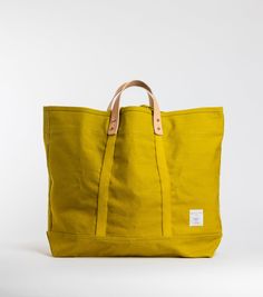 Constructed from custom-dyed Chartreuse 18oz cotton canvas, the Large East West Tote has copper hardware and is perfectly oversized to use at the market, beach or as a weekender. All East-West Totes convert from handheld to shoulder bag via detachable leather handles, which also means the Large size is washable (see ca Copper Hardware, Skin Hand, Pocket Notes, Small Sewing, Canvas Bags, Small Tote, East West, Leather Handles, Large Tote