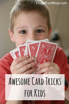 a young boy holding four red cards with the words, awesome card tricks for kids