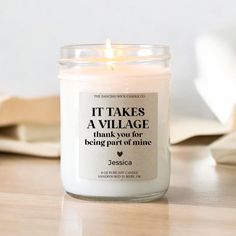 a white candle sitting on top of a wooden table