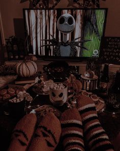 a table topped with lots of halloween treats and snacks on top of eachother