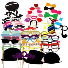 a bunch of different colored glasses and mustaches on sticks