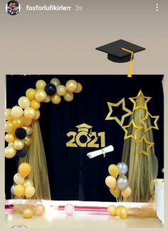 balloons and streamers in front of a graduation backdrop