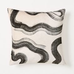 a black and white pillow with wavy lines on it