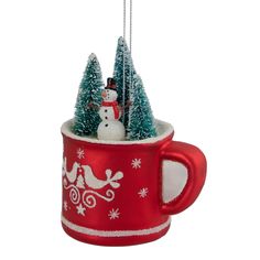 a red coffee cup with a snowman on top and trees in the bottom, hanging from a chain