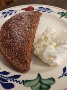 a piece of cake and whipped cream on a plate