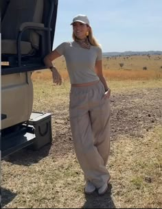 a woman standing in front of a safari vehicle