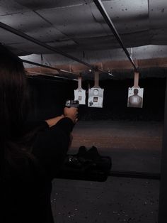 a woman is shooting an object in the dark