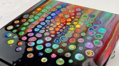 a laptop computer covered in multicolored circles