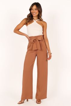 DETAILS    Step into timeless sophistication with our stylish Wide Leg Pant! The high-waisted design and gathered pleated waistband give you a flattering silhouette that's perfect for any occasion.   wide leg style pant  high waisted  gathered pleated waist band  front functional zip with hook and eye clasp  belt loops with detachable waist tie  functional pockets  lined   material - 100% polyester    SIZING    model is 5' 6" and wears a Size 2  model stats: bust - 31", waist - 23", hips - 34" High Waisted Wide Leg Jeans, Satin Dresses Long, Satin Dresses Long Sleeve, Black Tie Wedding Guests, White Dress Shoes, Style Pant, Essential Dress, Crop Top Tees, Wide Leg Pant