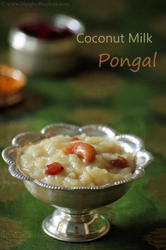 coconut milk pongal in a silver bowl on a green tablecloth with other food items