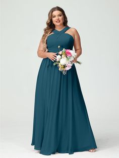 a woman in a long blue bridesmaid dress with flowers on the waist and shoulders