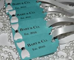 two baby and co tags with pearls on them