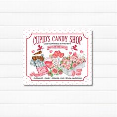 a candy shop sign with pink flowers and hearts on the front reads cupid's candy shop