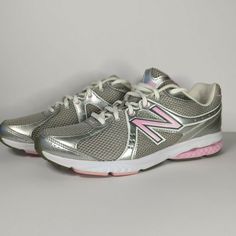 a pair of new balance shoes with pink soles