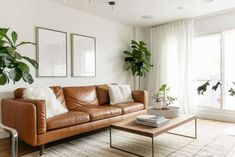 a living room filled with furniture and plants