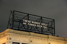 there is a sign on top of a building that says these words hold no power over you