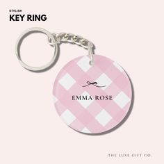 the key ring is pink and white checkered with an emma rose name on it