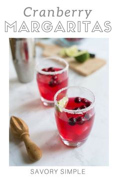 two glasses filled with cranberry margaritas on top of a white countertop