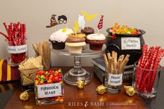 a table topped with lots of cupcakes and candy