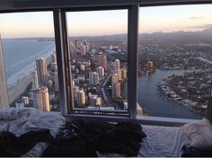 a view from the top of a high rise building looking down on a city and ocean