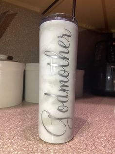 a white and black tumbler sitting on top of a counter