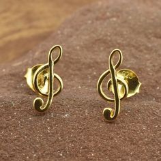 "Music note treble clef gold studs in Gold Vermeil. A perfect gift for the musician in your life, or to show your love of music. View matching necklace and gold and silver music notes here:- https://www.etsy.com/uk/shop/RoyalMileSilver?.=undefined&section_id=37605442 * Sold as a PAIR * A high quality, unique product * Pair Weight 0.8gr * Gift boxed * Ships direct from Edinburgh, Scotland * Supports a small artisan business \"Love music, Love Life !\" Vermeil is a technique originating in the 19th century, where gold is applied to sterling silver - making this a hypoallergenic product that can be worn without worry about the base metal being brass, copper or similar. We have created this to offer an affordable range of designs in gold and rose gold that can still be worn by those prone to s Personalized Gold Music-themed Jewelry, Music-themed Yellow Gold Jewelry Gift, Music Note Jewelry, Small Earrings Gold, Treble Clef, Love Music, Music Note, Edinburgh Scotland, Earrings In Gold