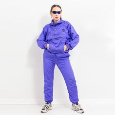 Vintage 90's Pierre Cardin tracksuit in purple - pullover jacket with a half zip - embroidered logo on the chest - elastic waist pants - the jacket has three pockets and the pants have two - lined - material: 100% nylon; lining - 65% polyester, 35% cotton SIZE from the tag: M JACKET: bust: 51 inches (118 cm) length: 24 inches (67 cm) sleeve length from the neck: 31 inches (71 cm) PANTS: waist circumference: 31-39.5 inches (78-100 cm) hips circumference: 43.5 inches (110 cm) rise: 12 inches (31 c Sporty Purple Windbreaker With Pockets, Violet Vintage, Shell Suit, Womens Sports, Vintage Purple, Elastic Waist Pants, Pullover Jacket, Pierre Cardin, Sports Women