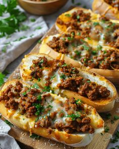 three stuffed breads filled with meat and cheese on a cutting board